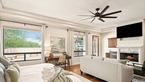 A spacious bedroom with a large bed, a white sofa, and a fireplace. - Scottsdale Rose Sleeps 40 Pool Pickleball Rooftop (Scottsdale)