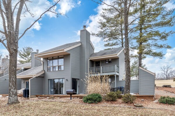 A two-story house with a balcony, large windows, and a chimney. - Lionshead Lake Home with Resort Access, Sleeps 11 (Innsbrook)