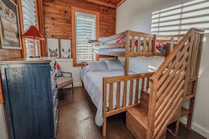 A bunk bed room with a desk and a chair, wooden walls, and a window with blinds. - Cozy Farm Stay at Top Hat Equestrian.  Horse and pet friendly! (Fairhope)