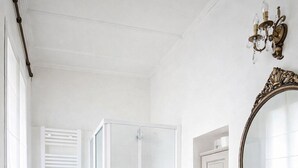 A modern bathroom with a glass shower enclosure, a pedestal sink, a toilet, and a bidet. - dHomes -Apartments Rooms- Galleria Gold  (Milan)