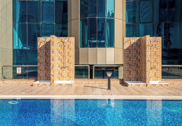 A swimming pool with a tiled edge and a 'No Diving' sign.