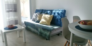 Relax in a cozy seating area with a sofa, pillows, and a small table.
