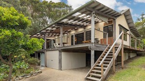 A two-story house with a covered outdoor area, a garage, and a staircase leading to the upper level. - Two Many Birds - Seal Rocks (Seal Rocks)
