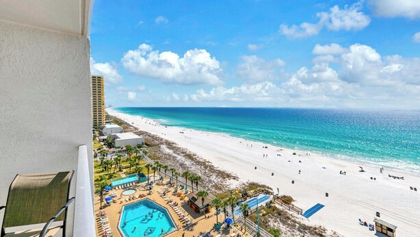 A beach resort with a pool, beach, and ocean view.