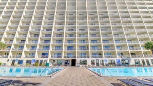 A large hotel with multiple balconies and a central entrance.