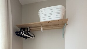 A closet with a wooden dresser and a shelf above it. - Bright apartment near the quays, ideal for discovering Quimper! (Quimper)