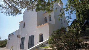 A multi-story building with a white facade, multiple windows with shutters, and a staircase leading to an upper level. - Luxury 8-person Villa with pool and sea view (Soalheira)