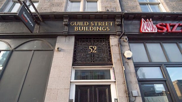 A building with a sign reading "Guild Street Buildings" and the number 52. - Guild Street Apartment | Grampian Lettings Ltd (Aberdeen)