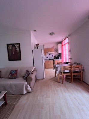 Cozy living space with a kitchenette, dining area, and seating area.