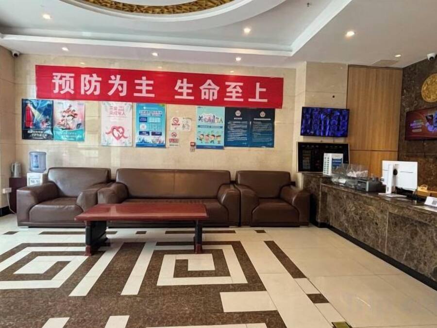 A reception area with a sofa, a coffee table, and a reception desk.