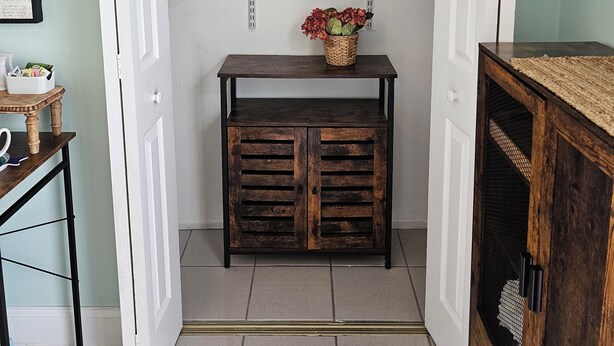 A walk-in closet with open doors, shelves, and a small table with a basket of flowers. - #1. Peaceful Private Room Near FLL Airport (Sunrise)
