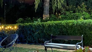 A well-maintained garden with a palm tree, a bench, and a satellite dish. - Relaxation, sea, nature, culture! (Sicilia)