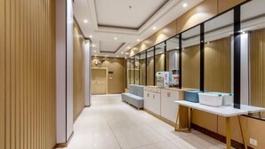 A modern hotel room with a large bed, a bedside table, and a window with blinds. - Fu Quan Hotel (Wuchuan Haibin Bus Terminal) (Wuchuan)