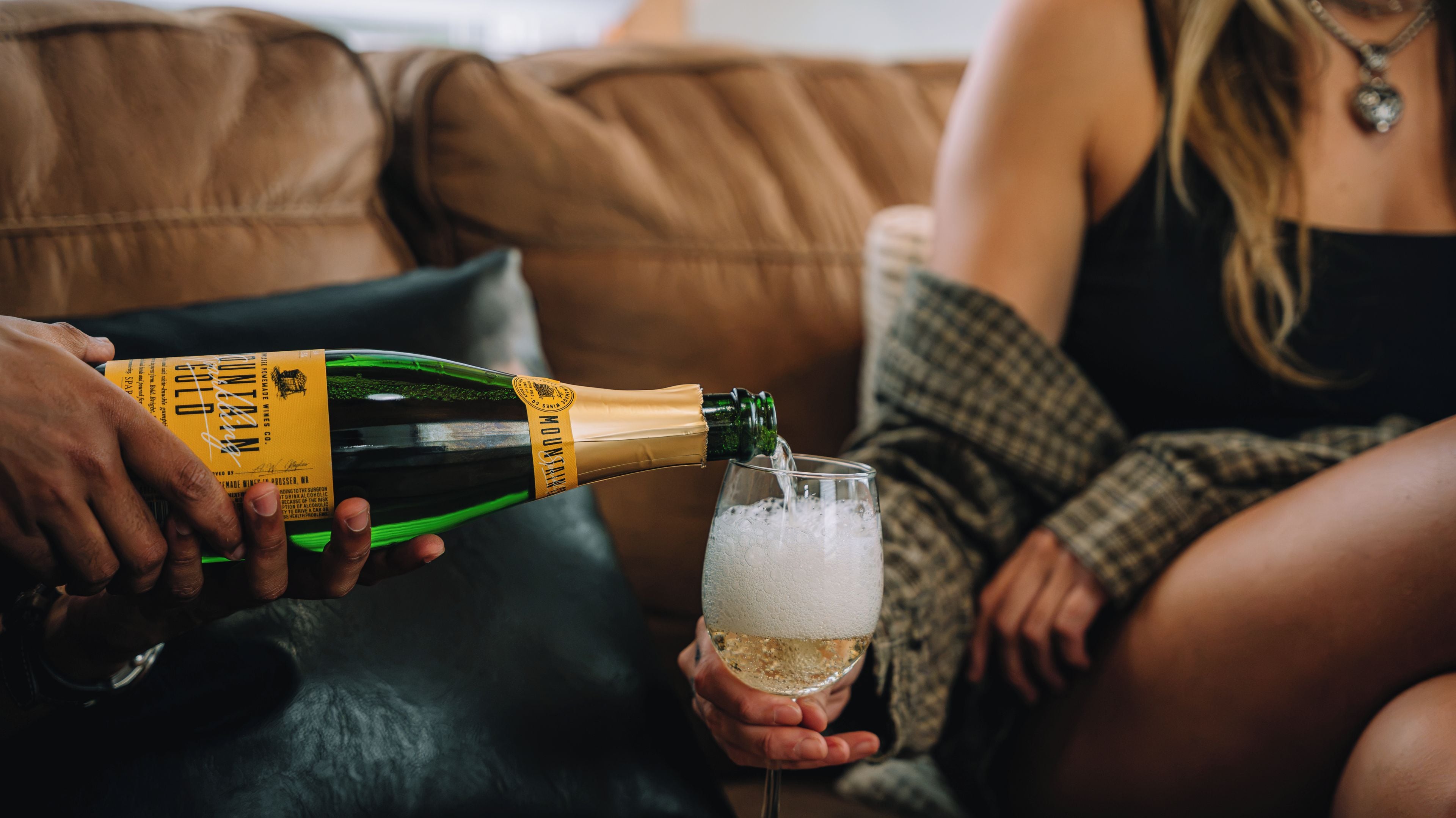 A person pouring champagne into a glass.