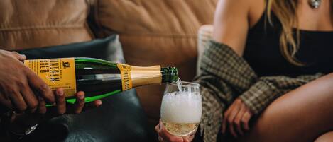 A person pouring champagne into a glass.