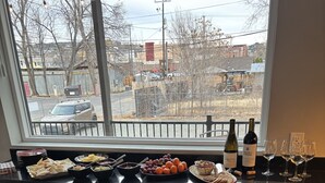 A bar area with a view of the street, a bottle of wine, and a bowl of grapes. - Dramatic New Home Right Downtown (Prescott)