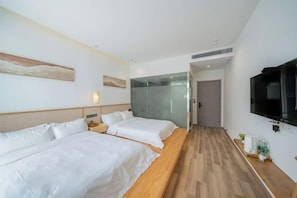 A hotel room with two beds, a TV, and a wooden floor. - Shanghai Dazaotou Homestay (Shanghai)