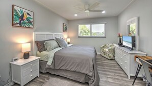 A bedroom with a bed, nightstands, a desk, a chair, a ceiling fan, and a window. - 5 min to Beach, Pool, Golf, BBQ! 1-bedroom penthouse w/elevator, WiFi, AC Naples (Naples)