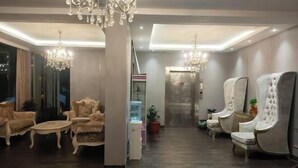 A modern hotel lobby with elegant chandeliers, plush seating, and a sleek reception area. - Margarita Boutique Hotel (Guangde)