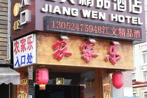 Segnaletica di un hotel con la scritta "JIANG WEN HOTEL" e un numero di telefono.