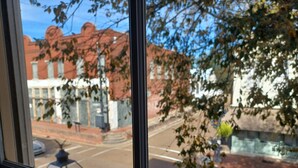 A view through a window with a street scene, including buildings and a street lamp. - Natchez Manor Bed & Breakfast (Natchez)