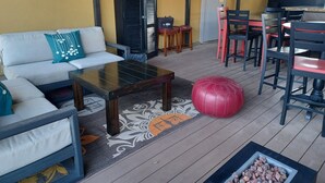 A cozy outdoor seating area with a sofa, coffee table, and chairs. - Natchez Manor Bed & Breakfast (Natchez)