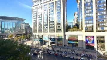 A multi-story building with a modern architectural design, featuring a large glass facade and a central entrance.