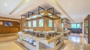 A buffet setup with multiple serving stations, a clean and modern interior, and a spacious layout. - Sea Trek Star Exquisite Hotel (Lishui)