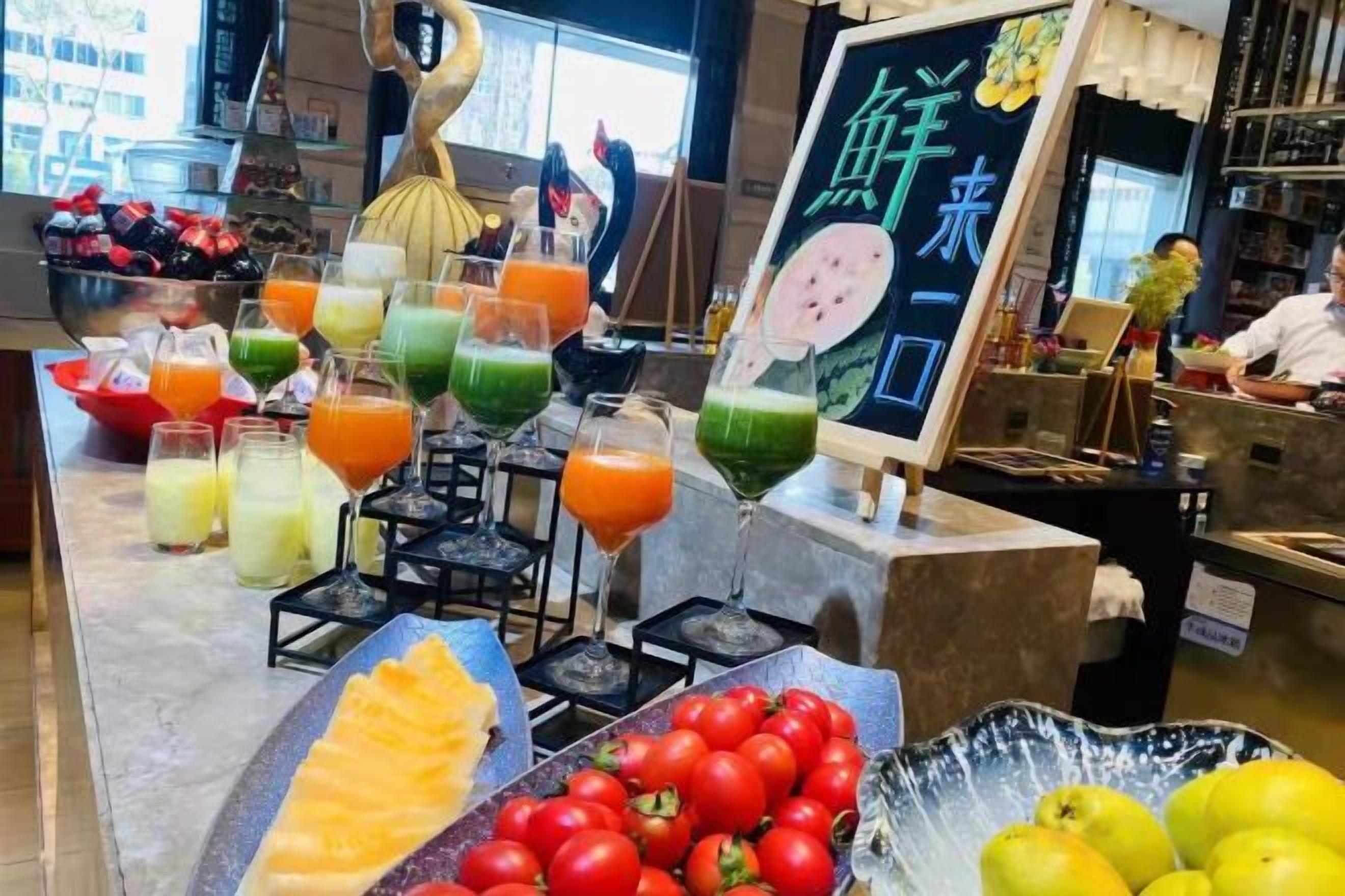 A bar area with a variety of drinks and fresh fruits.
