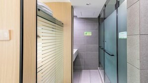 A narrow hallway with a wooden door on the left, a glass door on the right, and a tiled floor. - Naxiang Fujian Holiday Inn (Zhujiajian branch of Oriental Garden Hotel) (Zhoushan)