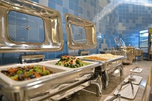 A buffet setup with multiple serving stations, each with a covered dish. - Homeinn Hotel (Dalian People's Square Xinkai Road) (Dalian)
