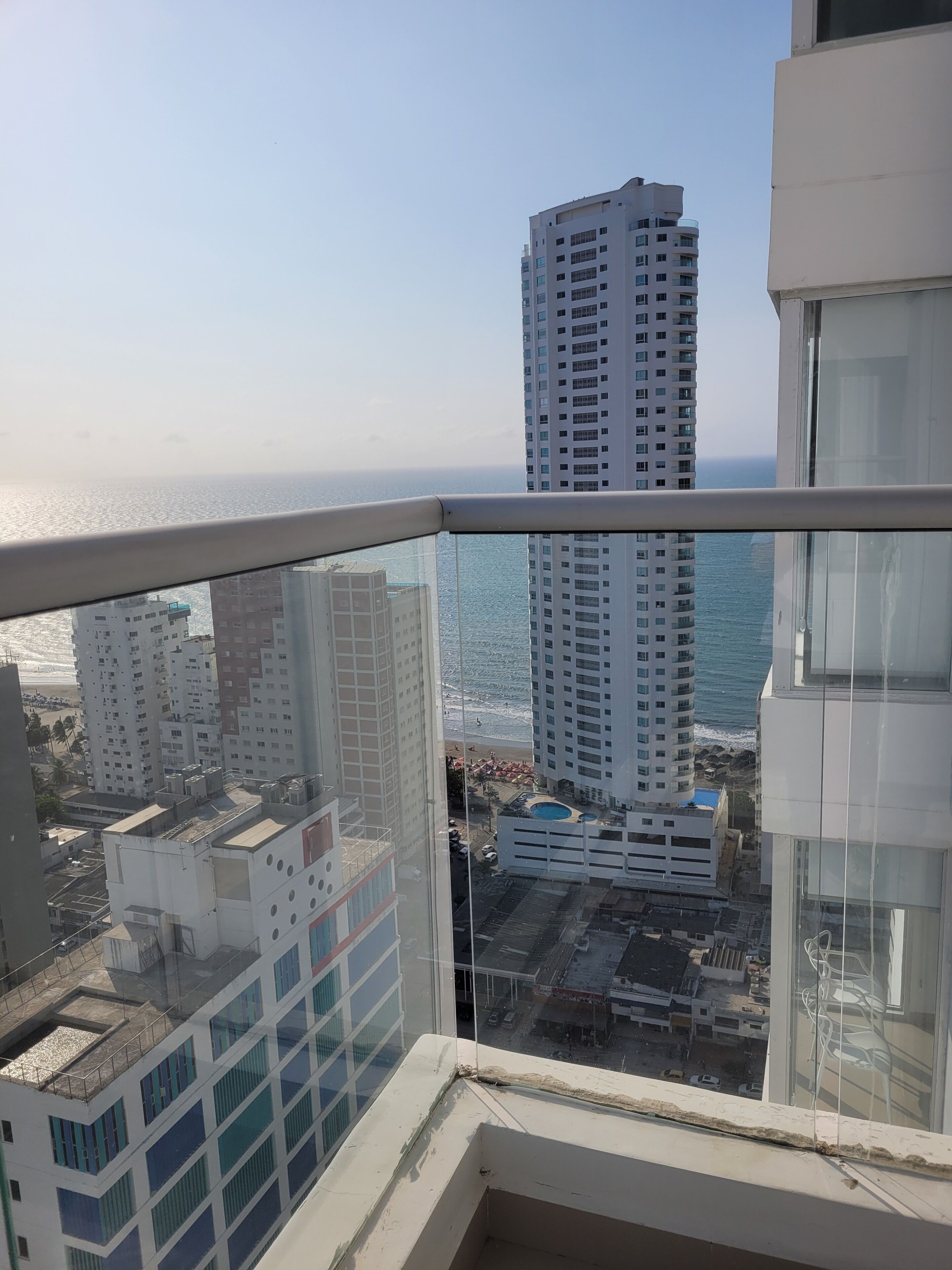 Ein Hochhaus mit Blick auf den Ozean und andere Gebäude.