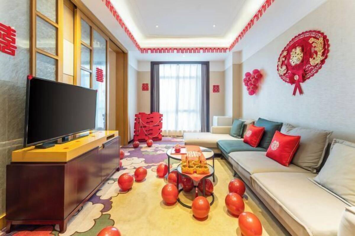 A modern living room with a flat-screen TV, a sofa, and a coffee table.