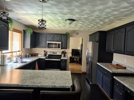 Fridge, microwave, oven, stovetop. Family friendly & Spacious; 4-bedroom home with movie room & game room