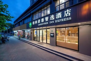 A hotel with a prominent sign for the GreenTree Inn Express. - GreenTree Inn Express (Shanghai City God's Temple BundYu Garden subway station shop) (Shanghai)