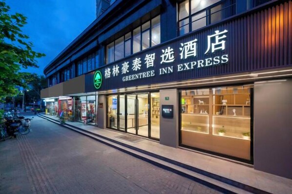 A hotel with a prominent sign for the GreenTree Inn Express.