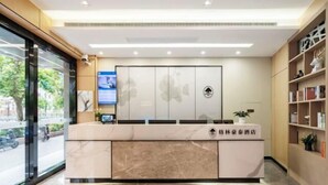 A reception desk with a marble top, a digital screen, and a wall-mounted sign. - GreenTree Inn Express (Shanghai City God's Temple BundYu Garden subway station shop) (Shanghai)