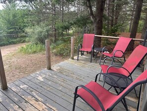A wooden deck with outdoor seating.