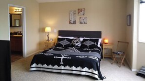 A bedroom with a bed, bedside lamps, a nightstand, a dresser, and a window. - 2 story, private, quiet upscale neighborhood MINUTES FROM 4 MAJOR SKI RESORTS (West Jordan)