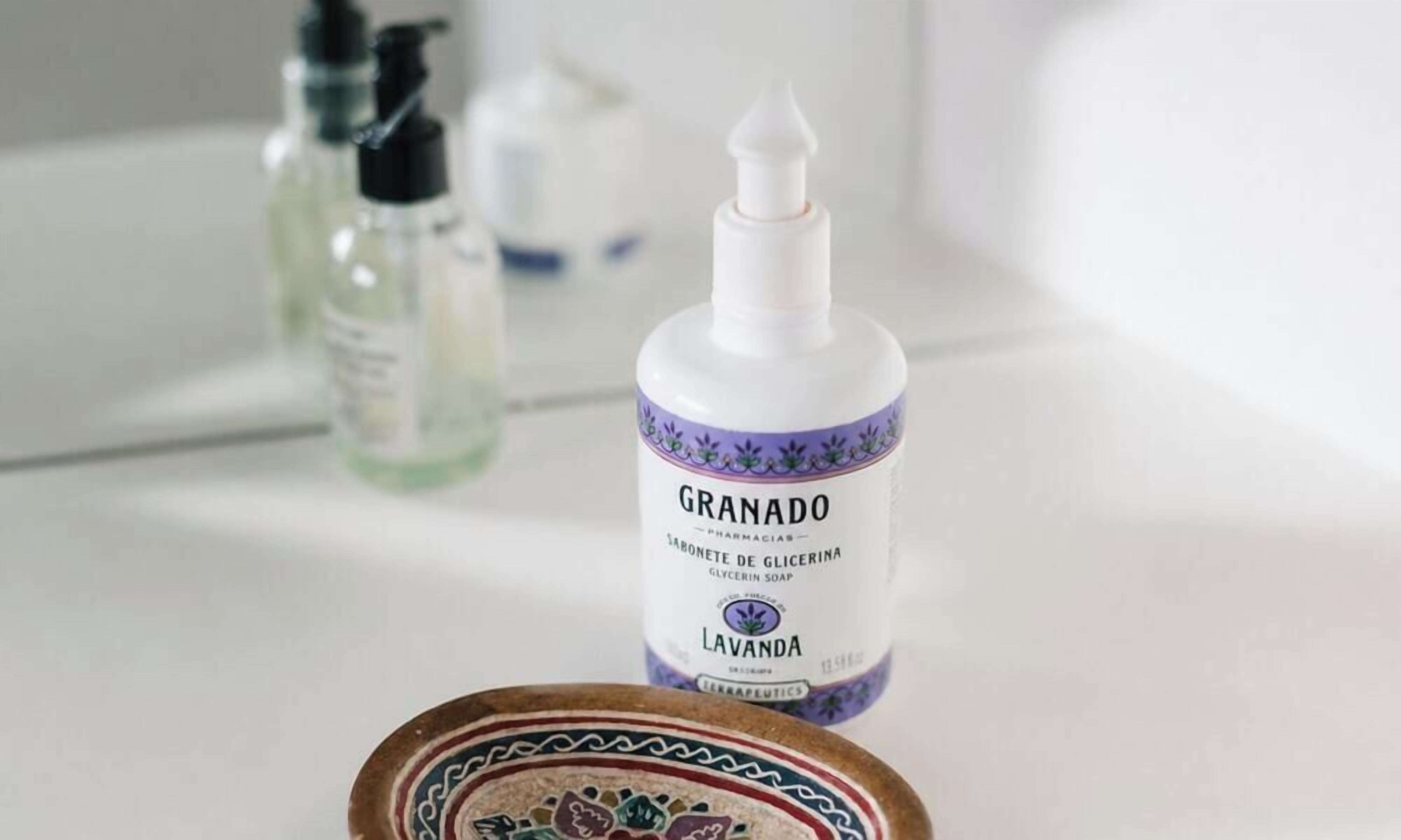A bathroom with a bottle of Granada soap and a soap dish.
