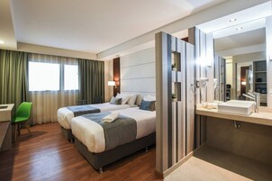 Cubrecamas, minibar y caja de seguridad en la habitación 