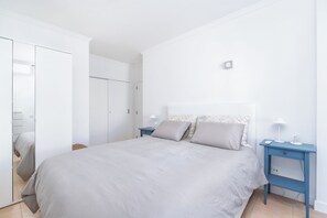 Sleep in comfort with a large bed, flanked by a wardrobe and nightstand.