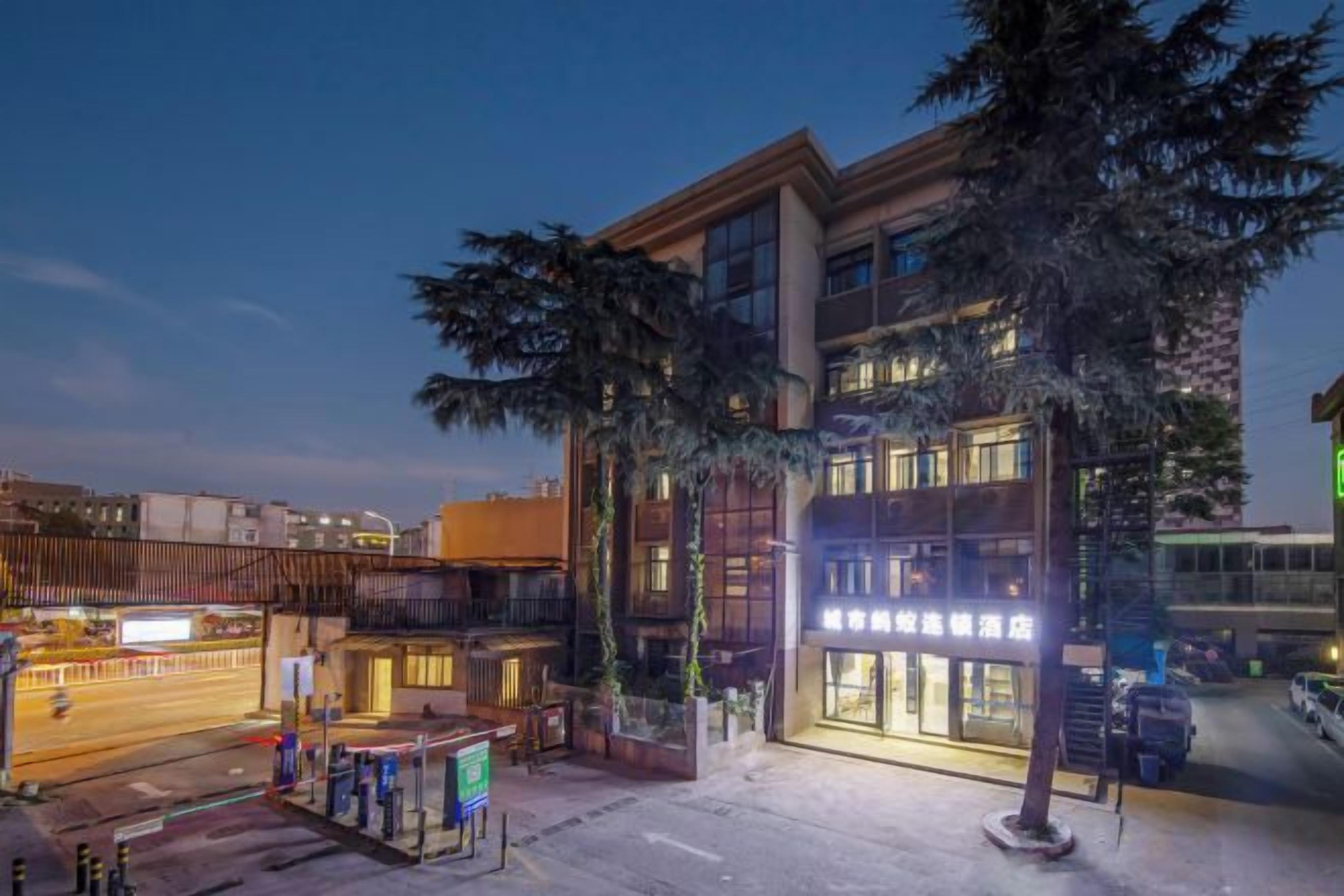 A multi-story building with a ground-level commercial space and a visible entrance.