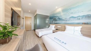 A hotel room with two beds, a desk, a chair, a TV, and a painting of a landscape. - City Ant Hotel (Nanjing Wutang Square Metro Station) (Nanjing)