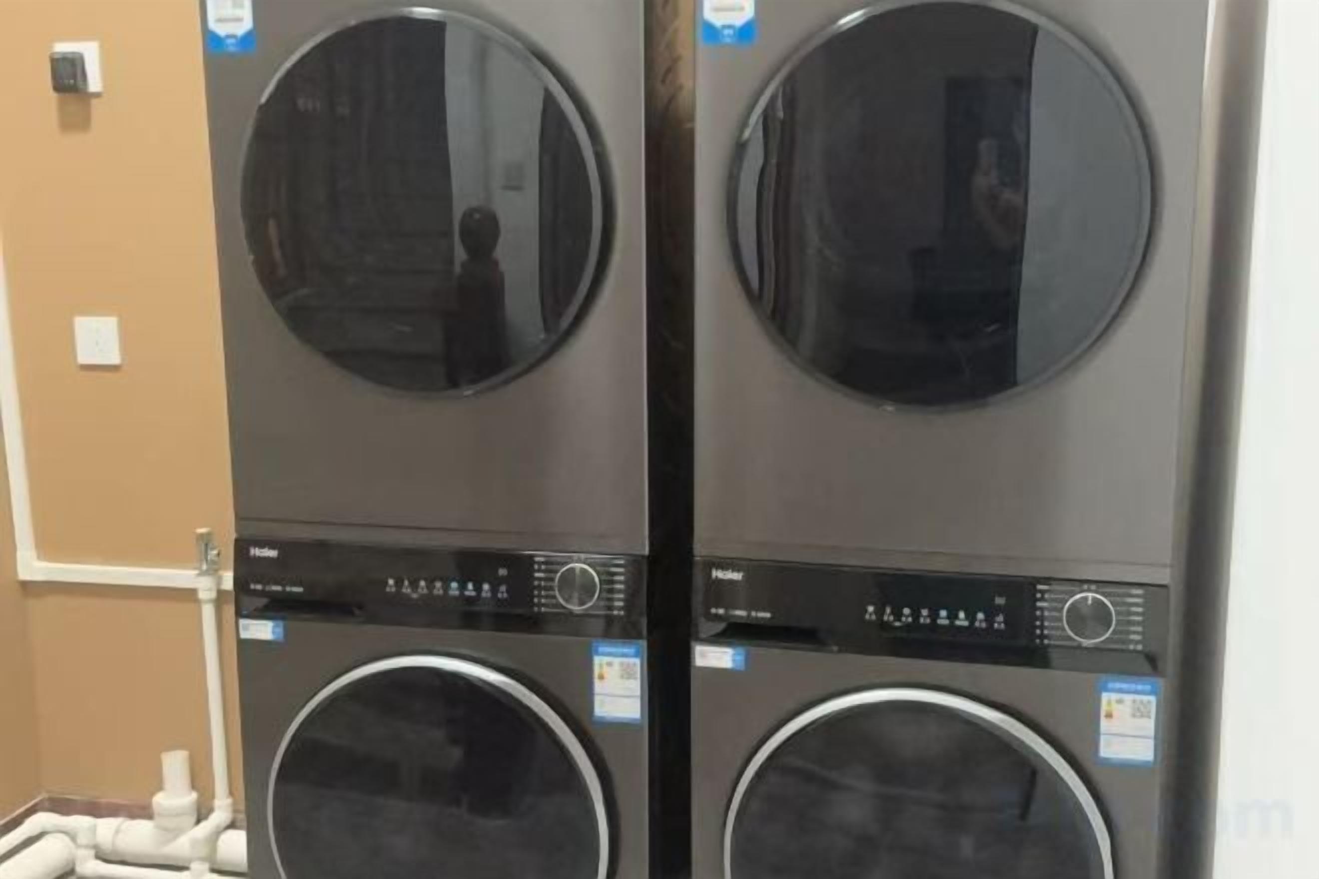 Two stacked front-loading washing machines with control panels.