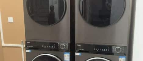 Two stacked front-loading washing machines with control panels.