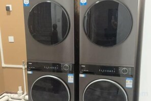 Two stacked front-loading washing machines with control panels. - Pinshang Express Chain Hotel (Dongxing Guomen Port) (Dongxing)