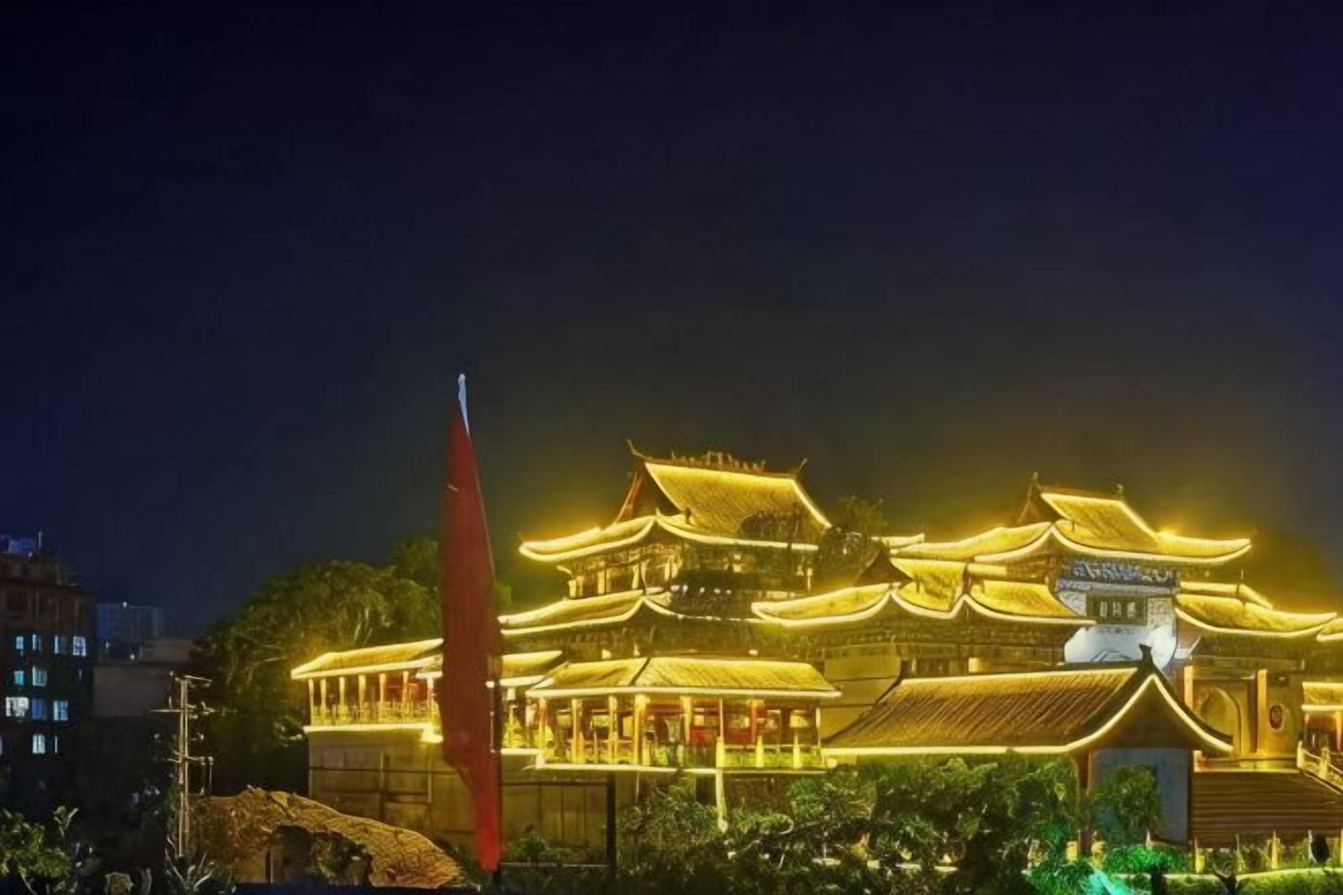 A traditional building with multiple levels and a prominent red flag.