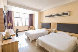 A hotel room with two beds, a desk with a lamp, a TV, and a large window with curtains. - Pinshang Express Chain Hotel (Dongxing Guomen Port) (Dongxing)