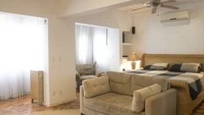 A bedroom with a bed, a ceiling fan, a bedside table, and a chair. - ROCK IN RIO 2026 PROMO Sep 5th to 14th
Best Location Best Living in Rio. (Rio de Janeiro)